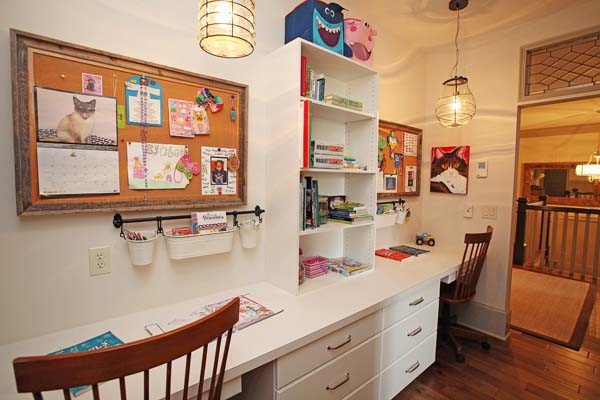 This is an example of a mid-sized traditional gender-neutral kids' study room in Charlotte with white walls and medium hardwood floors.