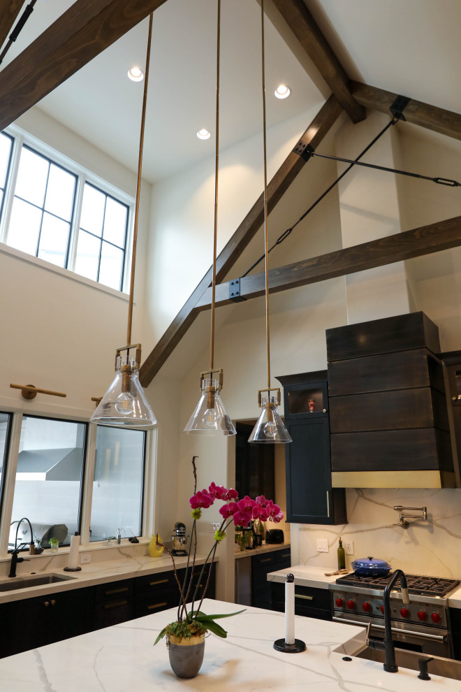 Example of a large transitional u-shaped light wood floor open concept kitchen design with a farmhouse sink, flat-panel cabinets, dark wood cabinets, quartz countertops, white backsplash, quartz backsplash, stainless steel appliances, an island and white countertops