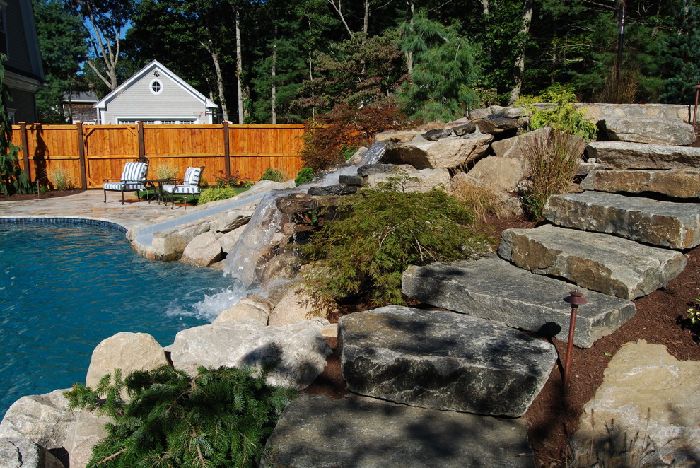 Inspiration for a mid-sized rustic backyard stone and kidney-shaped natural water slide remodel in Boston