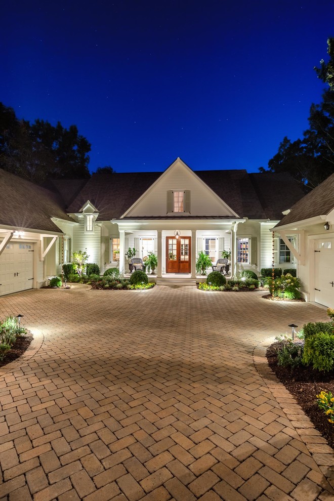 Photo of a large traditional full sun front yard brick driveway in New York for summer.