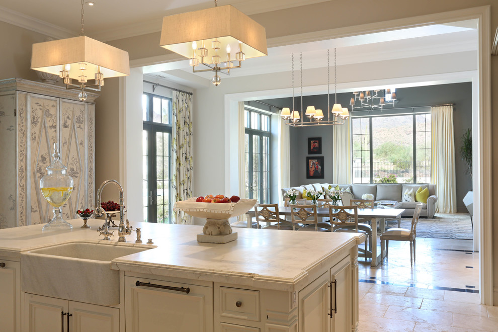 Large traditional single-wall open plan kitchen in Phoenix with a farmhouse sink, raised-panel cabinets, white cabinets, marble benchtops, stainless steel appliances, marble floors and with island.