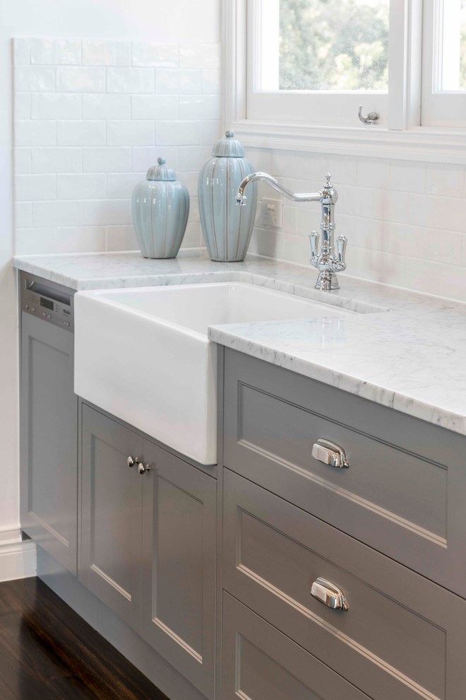 Inspiration for a mid-sized traditional eat-in kitchen in Brisbane with a farmhouse sink, shaker cabinets, grey cabinets, marble benchtops, white splashback, subway tile splashback, white appliances, dark hardwood floors and with island.