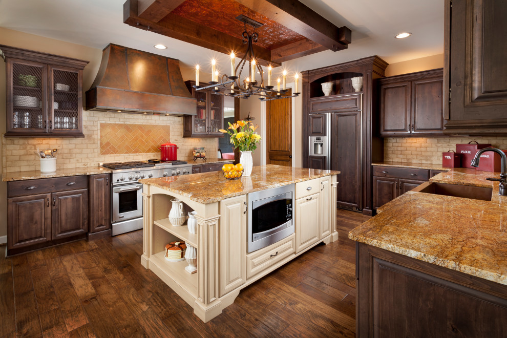 Inspiration for a large timeless u-shaped medium tone wood floor and brown floor kitchen remodel in Detroit with an undermount sink, raised-panel cabinets, medium tone wood cabinets, brown backsplash, stainless steel appliances, an island and brown countertops