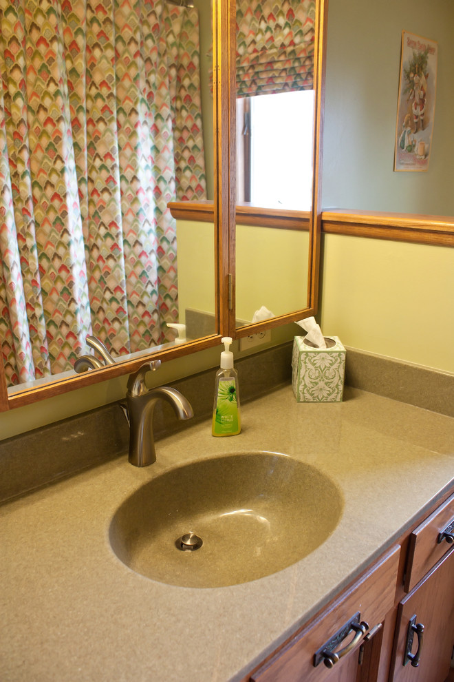 Inspiration for a mid-sized traditional bathroom in Wichita with green walls, vinyl floors and solid surface benchtops.