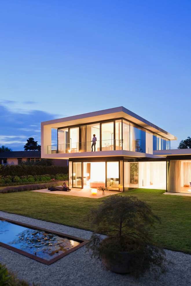 This is an example of a large contemporary two-storey exterior in Stuttgart with a flat roof.
