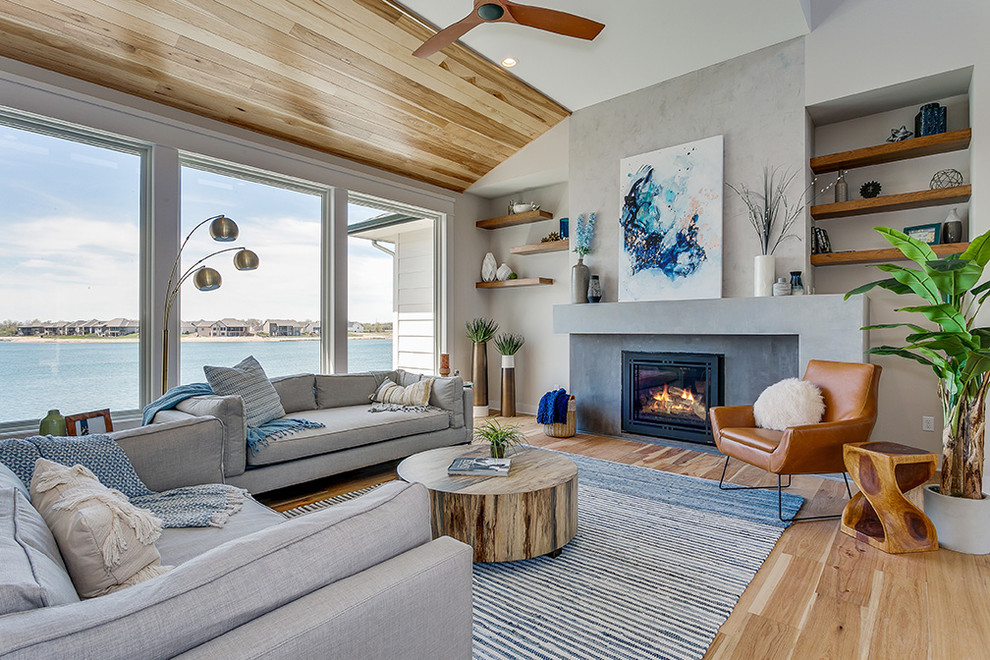 Inspiration for a beach style living room in Wichita with grey walls, light hardwood floors and a standard fireplace.