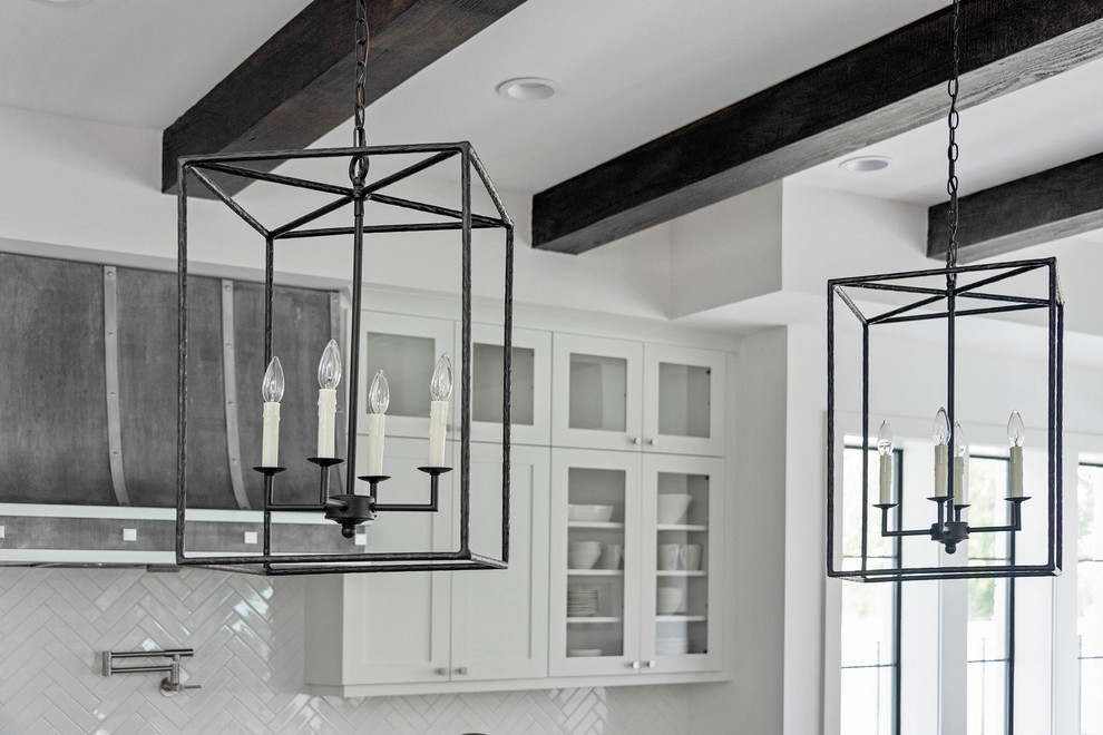 Inspiration for a large transitional l-shaped medium tone wood floor eat-in kitchen remodel in Orlando with a farmhouse sink, glass-front cabinets, white cabinets, marble countertops, white backsplash, mosaic tile backsplash, stainless steel appliances, an island and white countertops