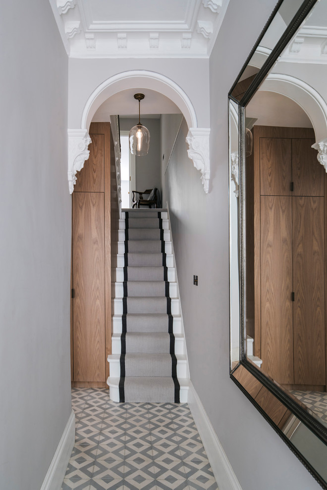 Photo of a mid-sized traditional hallway in London with ceramic floors.