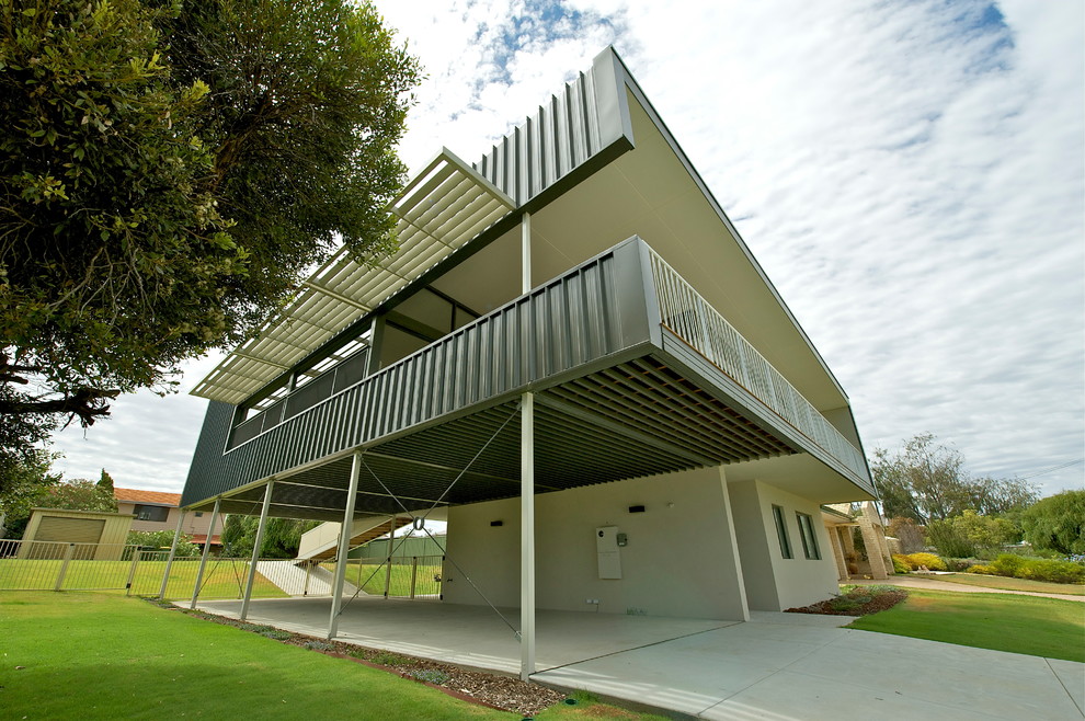 This is an example of a beach style two-storey beige exterior in Perth with a flat roof.