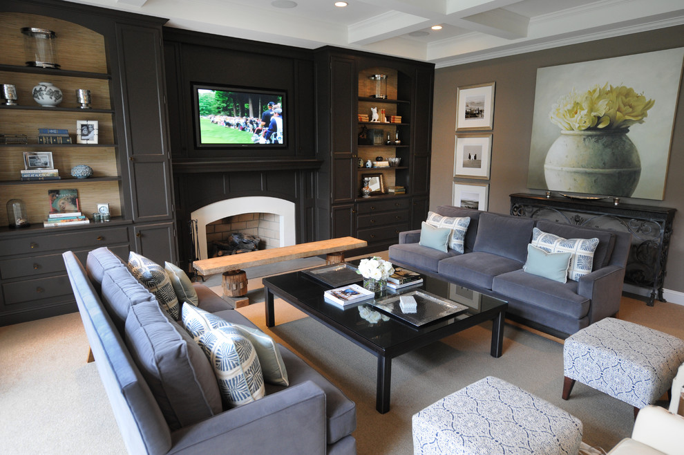 This is an example of a traditional family room in Philadelphia with beige walls, carpet, a standard fireplace and a built-in media wall.
