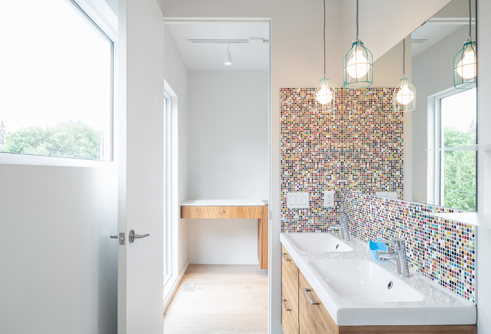 This is an example of a contemporary kids bathroom in Ottawa with an integrated sink, multi-coloured tile and mosaic tile.