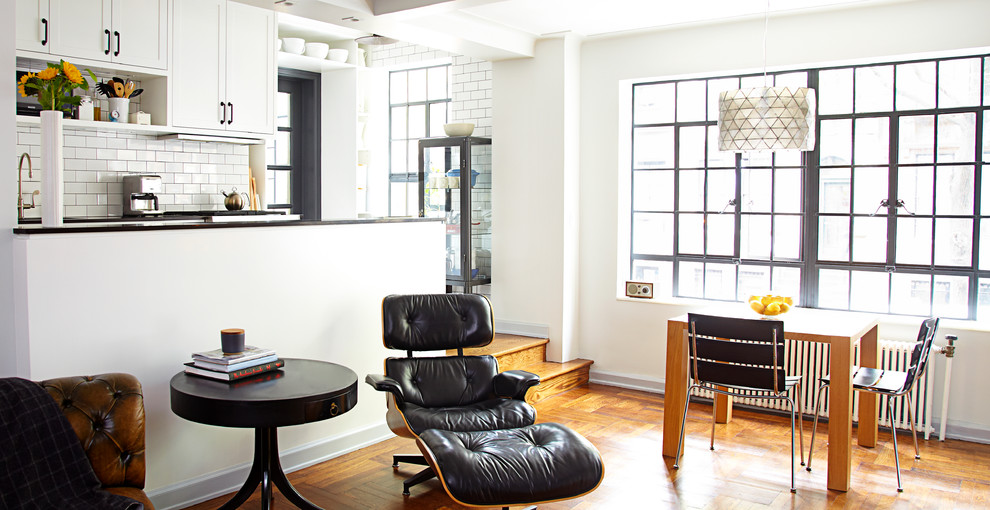 Small transitional u-shaped medium tone wood floor eat-in kitchen photo in New York with a single-bowl sink, recessed-panel cabinets, white cabinets, quartz countertops, white backsplash, ceramic backsplash, stainless steel appliances and a peninsula