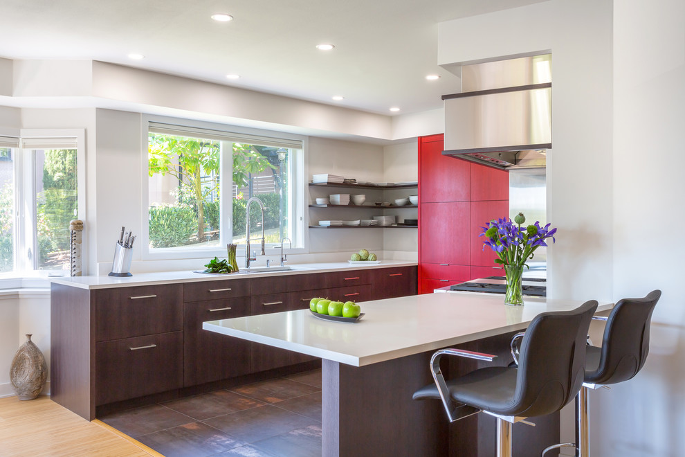 Inspiration for a mid-sized contemporary u-shaped eat-in kitchen in Seattle with flat-panel cabinets, black cabinets, quartz benchtops, a peninsula, an undermount sink, white splashback, stone slab splashback, stainless steel appliances and porcelain floors.