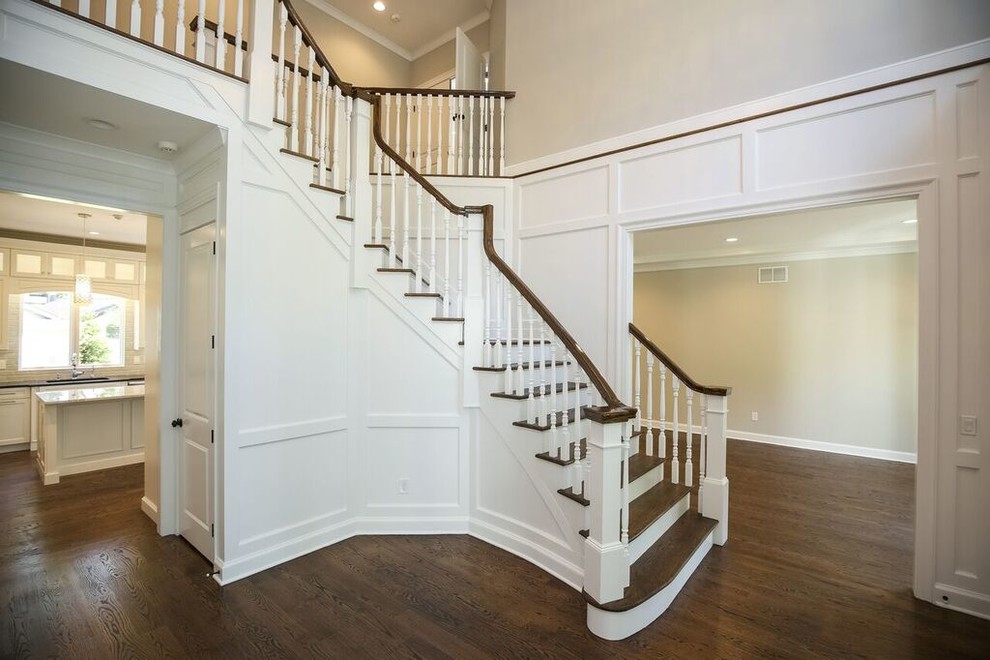 Design ideas for a large transitional wood curved staircase in New York with painted wood risers.