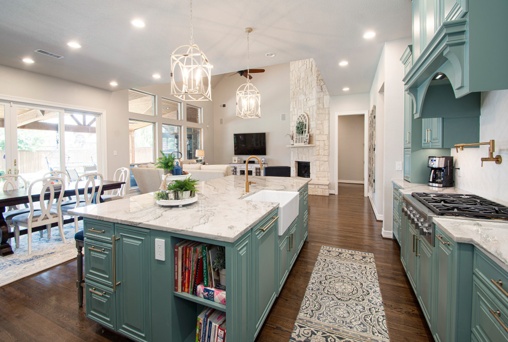Open concept kitchen - large transitional l-shaped medium tone wood floor and brown floor open concept kitchen idea in Dallas with a farmhouse sink, raised-panel cabinets, green cabinets, quartzite countertops, white backsplash, stainless steel appliances, an island, white countertops and ceramic backsplash