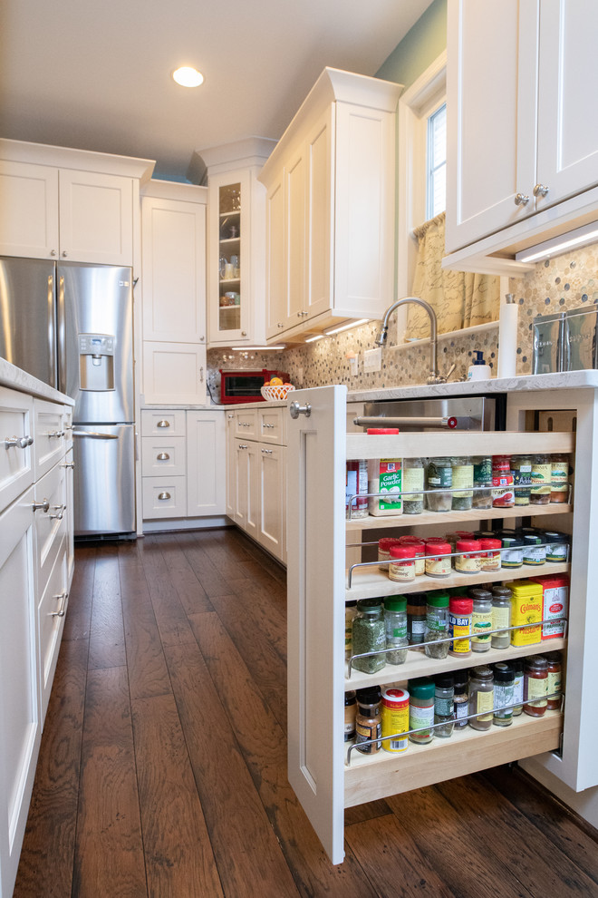 Inspiration for a large transitional u-shaped dark wood floor and brown floor eat-in kitchen remodel in DC Metro with an undermount sink, flat-panel cabinets, white cabinets, quartz countertops, multicolored backsplash, mosaic tile backsplash, stainless steel appliances, an island and white countertops