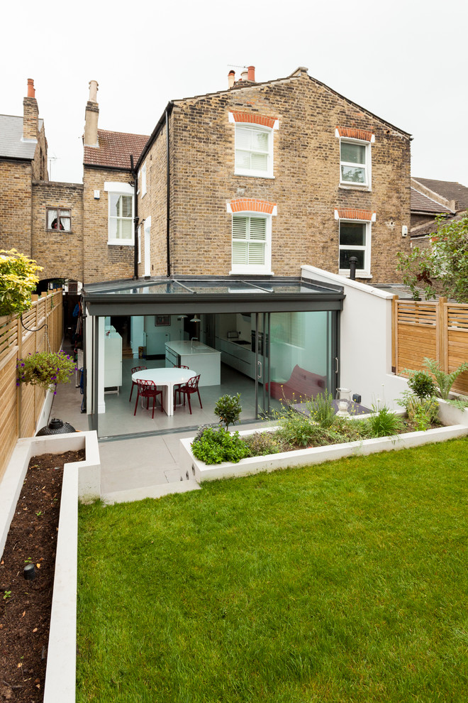 Inspiration for a contemporary three-storey brick exterior in London with a gable roof.