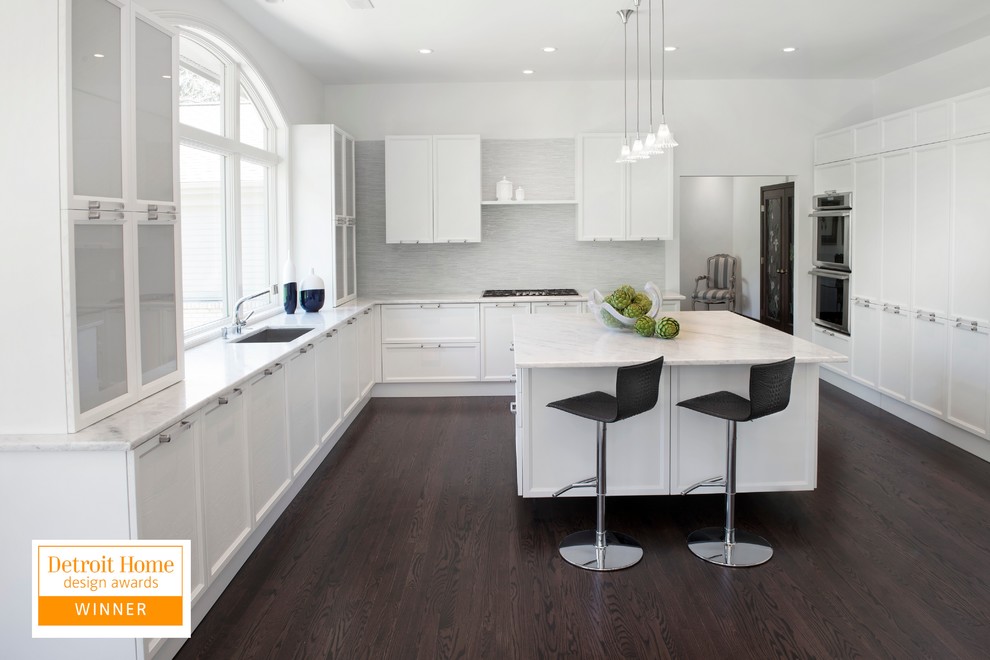 Large transitional u-shaped dark wood floor eat-in kitchen photo with an undermount sink, recessed-panel cabinets, white cabinets, quartzite countertops, white backsplash, paneled appliances, yellow walls and an island