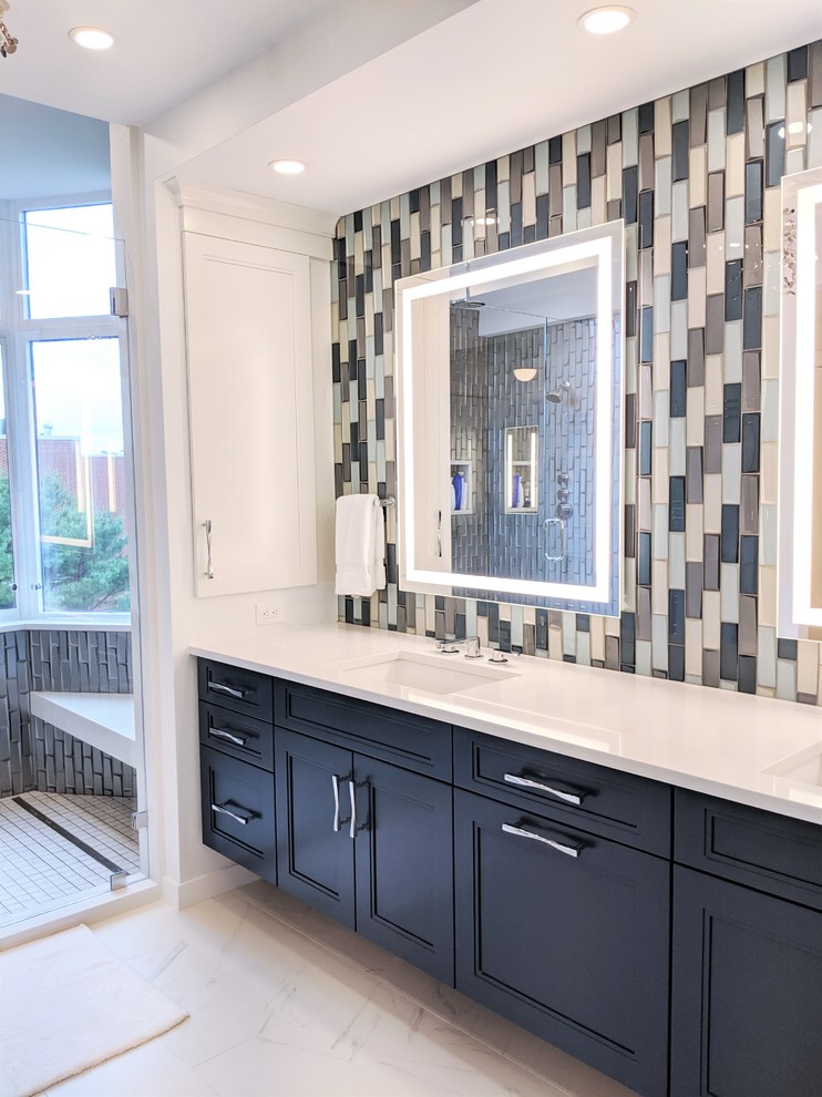 Design ideas for a large modern master bathroom in Boston with shaker cabinets, blue cabinets, an open shower, blue tile, subway tile, white walls, marble floors, an undermount sink, quartzite benchtops, white floor, a hinged shower door and white benchtops.