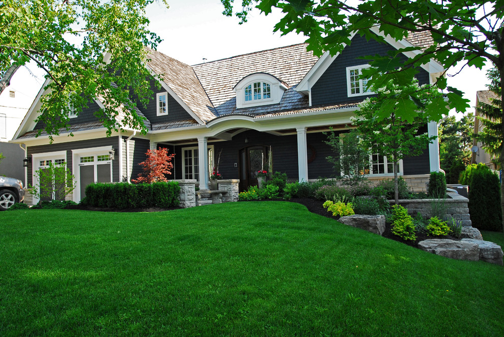 Design ideas for a large rustic full sun backyard stone formal garden in Toronto for summer.
