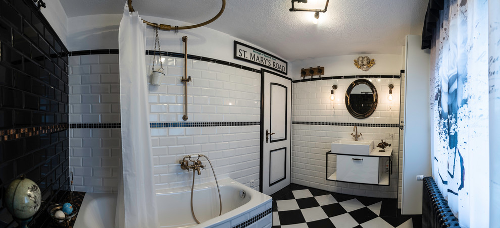 Mid-sized industrial 3/4 bathroom in Other with glass-front cabinets, white cabinets, an undermount tub, a two-piece toilet, black and white tile, subway tile, white walls, ceramic floors, a vessel sink, stainless steel benchtops, black floor, a shower curtain and white benchtops.