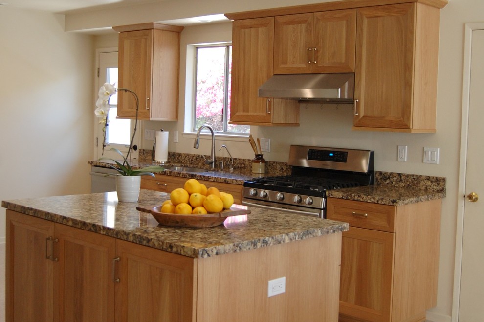 This is an example of a mid-sized traditional galley eat-in kitchen in Santa Barbara with a drop-in sink, recessed-panel cabinets, light wood cabinets, quartz benchtops, brown splashback, stone slab splashback, stainless steel appliances, linoleum floors, with island, beige floor and brown benchtop.