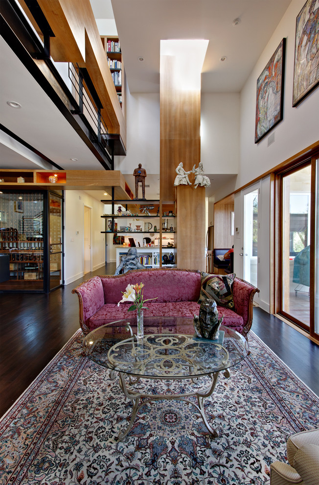 This is an example of a modern open concept living room in Austin with dark hardwood floors.