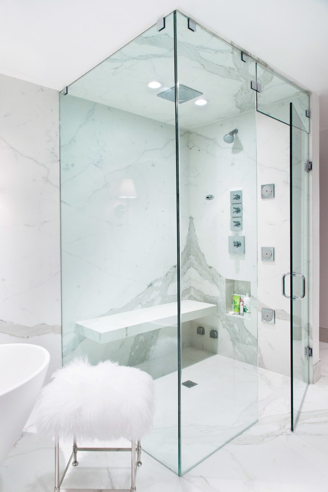 This is an example of a modern bathroom in Chicago with an undermount sink, flat-panel cabinets, medium wood cabinets, solid surface benchtops, a freestanding tub, a corner shower, a one-piece toilet, white tile and porcelain tile.