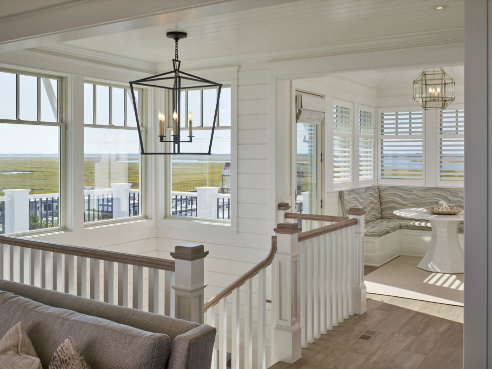 Photo of a large beach style hallway in Other with white walls, medium hardwood floors and wood.