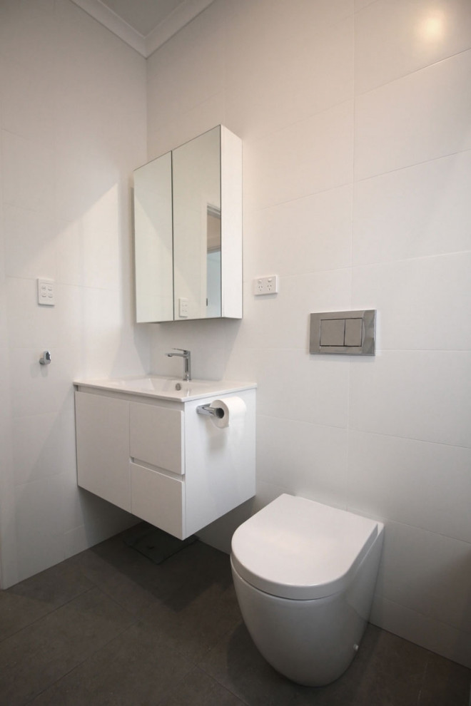 Photo of a mid-sized contemporary master bathroom in Melbourne with beaded inset cabinets, white cabinets, an alcove tub, a shower/bathtub combo, white tile, porcelain tile, beige walls, porcelain floors, a vessel sink, engineered quartz benchtops, brown floor, a hinged shower door, white benchtops, a single vanity and a floating vanity.