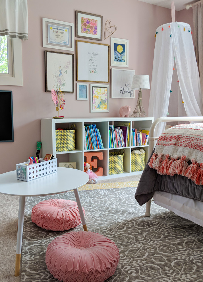 Photo of a mid-sized transitional kids' bedroom for kids 4-10 years old and girls in Other with pink walls, carpet and beige floor.