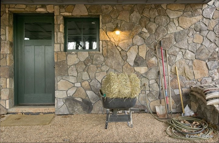 Inspiration for a country exterior in Other with stone veneer.