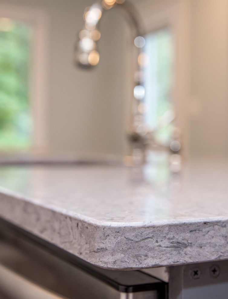 Home design - mid-sized transitional l-shaped brown floor home design idea in Atlanta with an undermount sink, white cabinets, quartzite countertops, white backsplash, subway tile backsplash, stainless steel appliances, an island and gray countertops