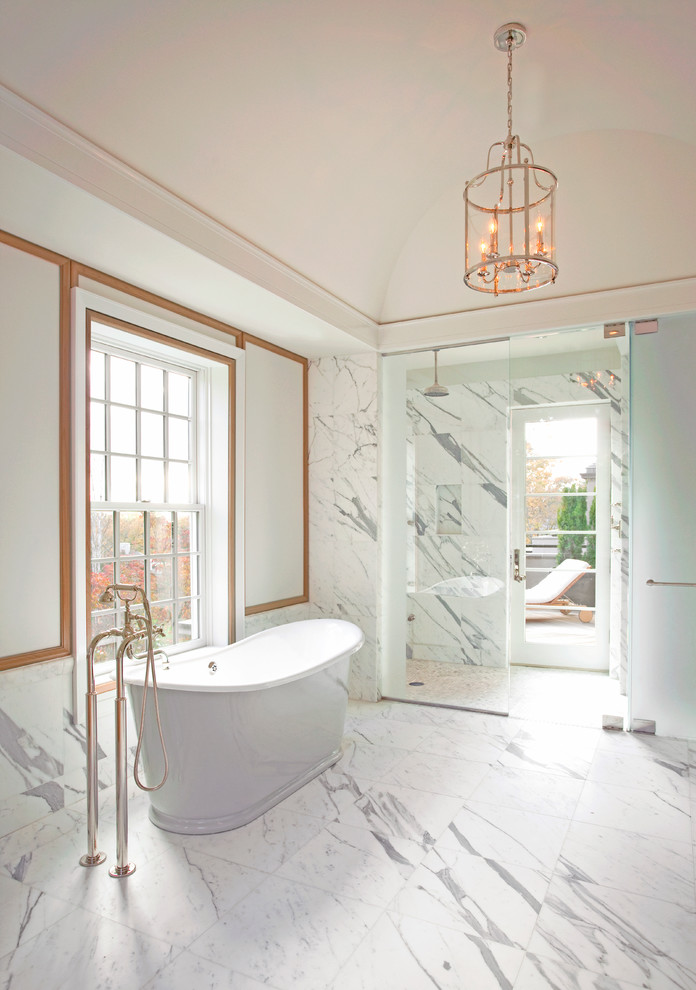 This is an example of a transitional bathroom in Boston with a freestanding tub, a curbless shower, white tile and white walls.