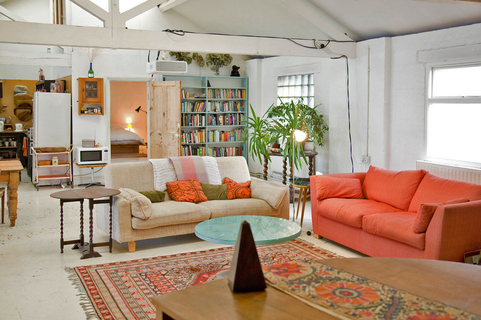 This is an example of a mid-sized eclectic open concept living room in London with white walls.
