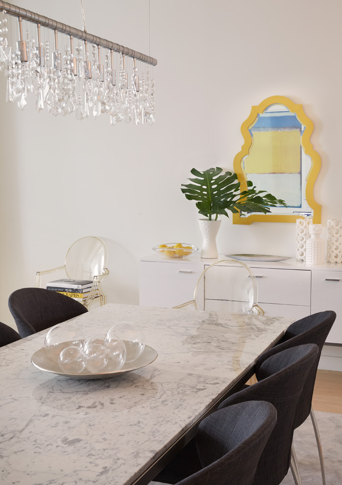 Photo of a contemporary separate dining room in Other with white walls and light hardwood floors.