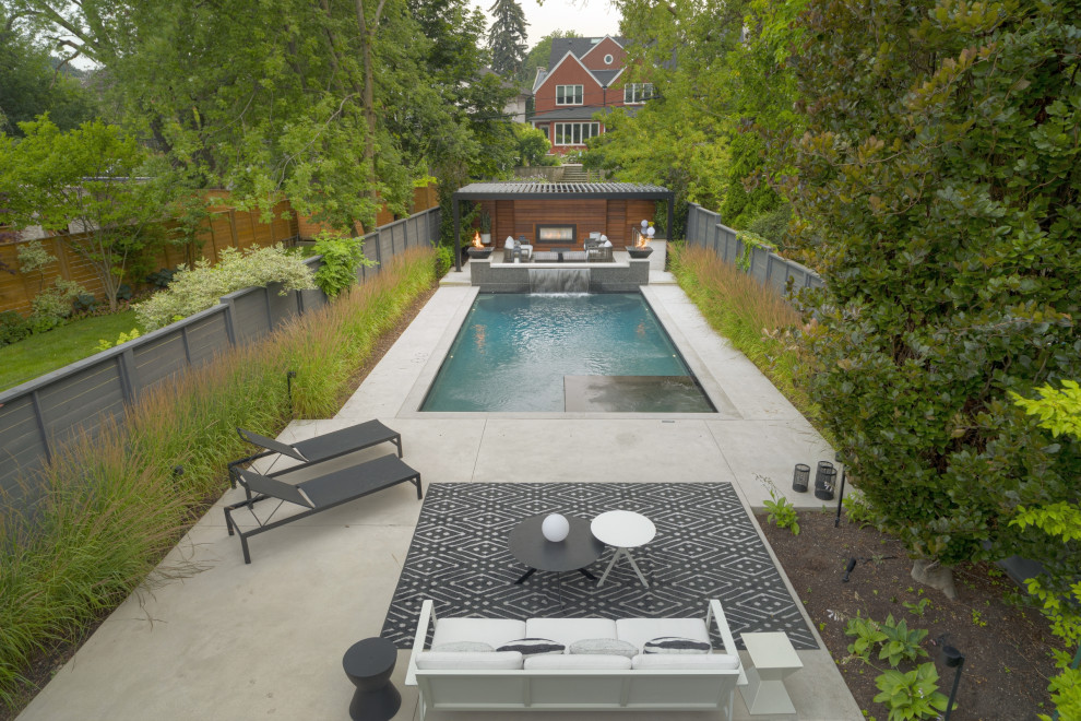 Design ideas for a small transitional backyard rectangular pool in Toronto with with a pool and stamped concrete.