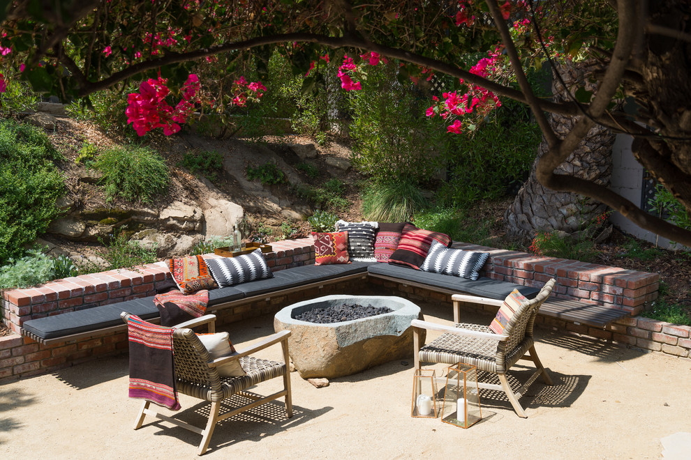 Example of a small minimalist backyard patio design in Los Angeles with a fire pit