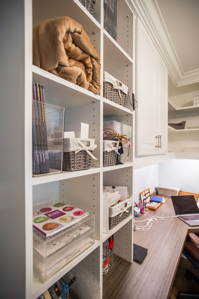 Study room - mid-sized transitional built-in desk light wood floor and brown floor study room idea in Denver with gray walls