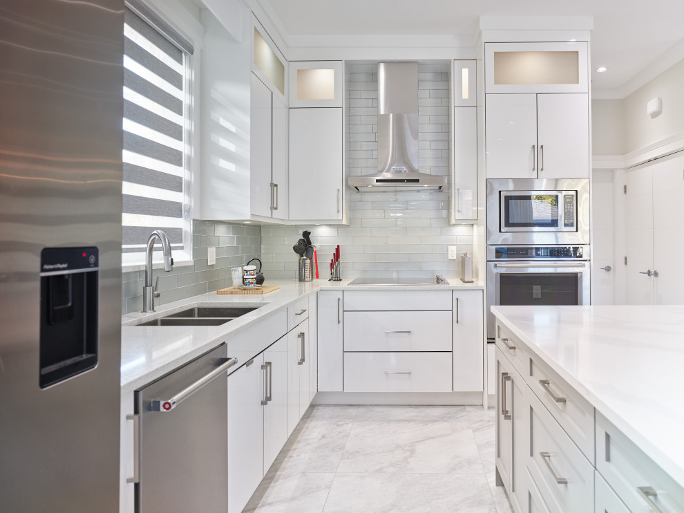 This is an example of a mid-sized modern l-shaped kitchen pantry in Vancouver with a drop-in sink, flat-panel cabinets, white cabinets, quartzite benchtops, grey splashback, glass tile splashback, stainless steel appliances, porcelain floors, with island, white floor, white benchtop and vaulted.