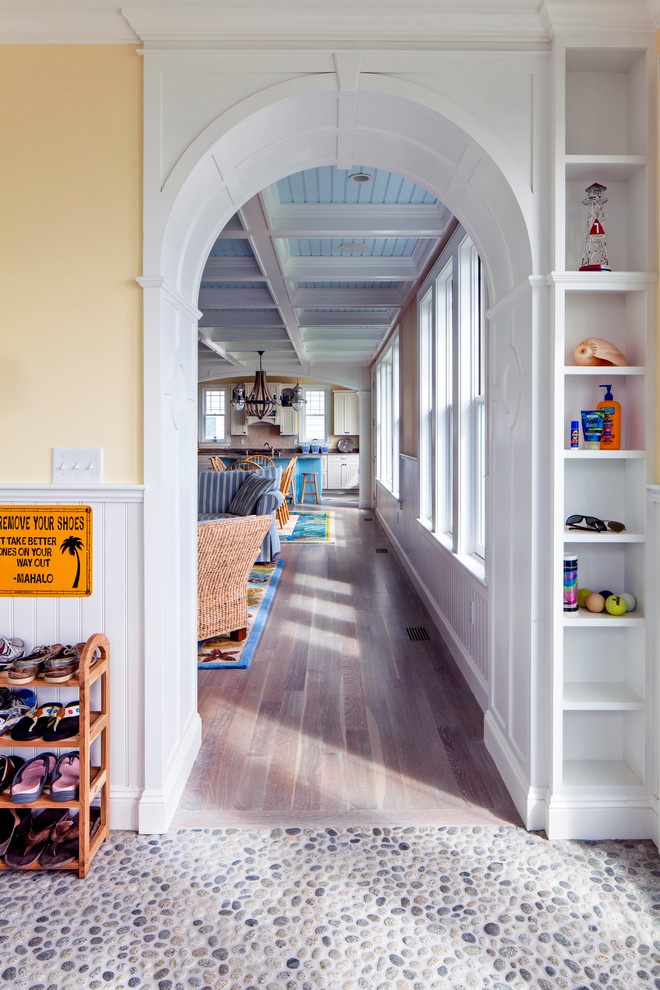 Inspiration for a mid-sized beach style entry hall in Portland Maine with yellow walls.