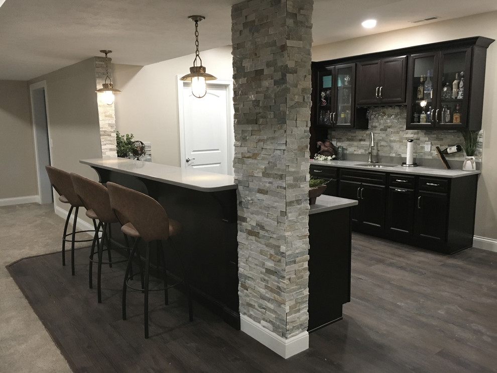 Inspiration for a mid-sized single-wall wet bar in Other with an undermount sink, recessed-panel cabinets, dark wood cabinets, quartz benchtops, multi-coloured splashback, stone tile splashback, laminate floors, multi-coloured floor and grey benchtop.