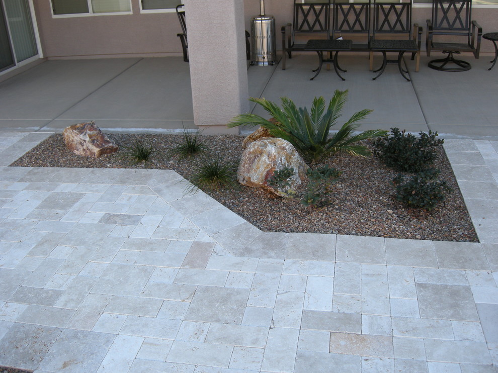 This is an example of a mid-sized contemporary backyard partial sun xeriscape for summer in Phoenix with a fire feature and gravel.