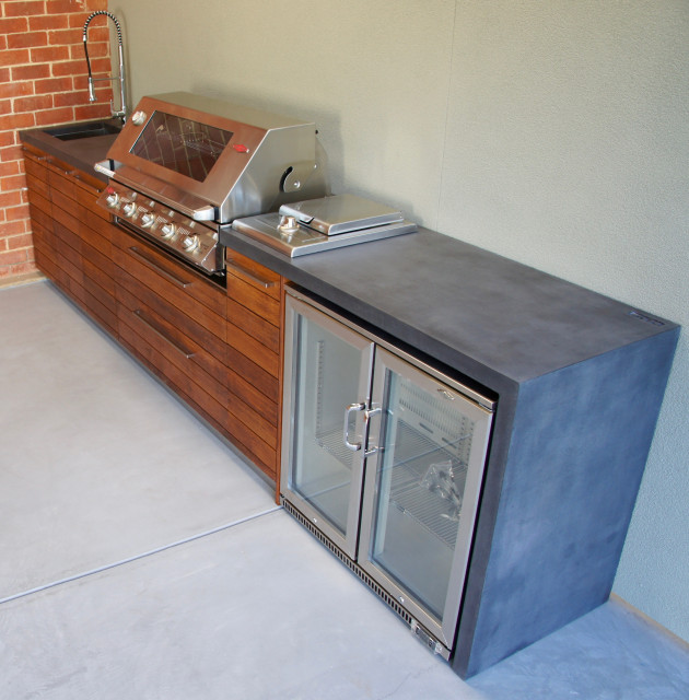 Outdoor Kitchen with a polished concrete benchtop & hardwood doors