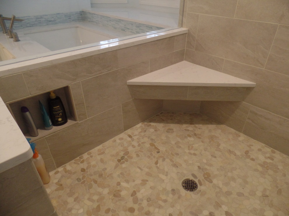 Corner shower - large transitional master gray tile and porcelain tile porcelain tile corner shower idea with an undermount sink, shaker cabinets, white cabinets, quartz countertops, an undermount tub, a two-piece toilet and blue walls