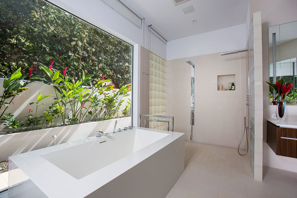 Inspiration for a large contemporary master bathroom in Hawaii with flat-panel cabinets, a freestanding tub, a double shower, white tile, white walls and ceramic floors.