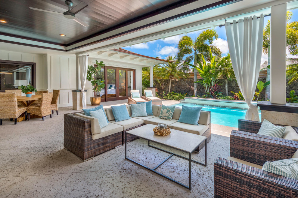 This is an example of a tropical patio in Hawaii with a roof extension.