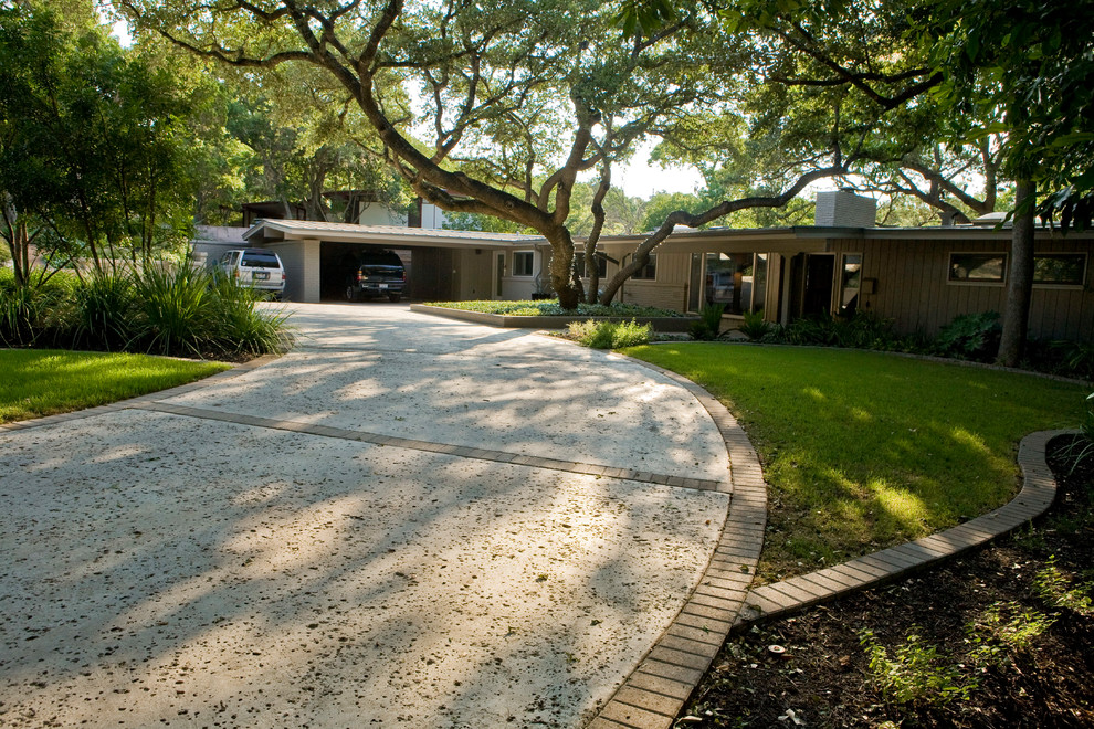 Inspiration for a mid-sized midcentury one-storey beige exterior in Austin with wood siding and a gable roof.