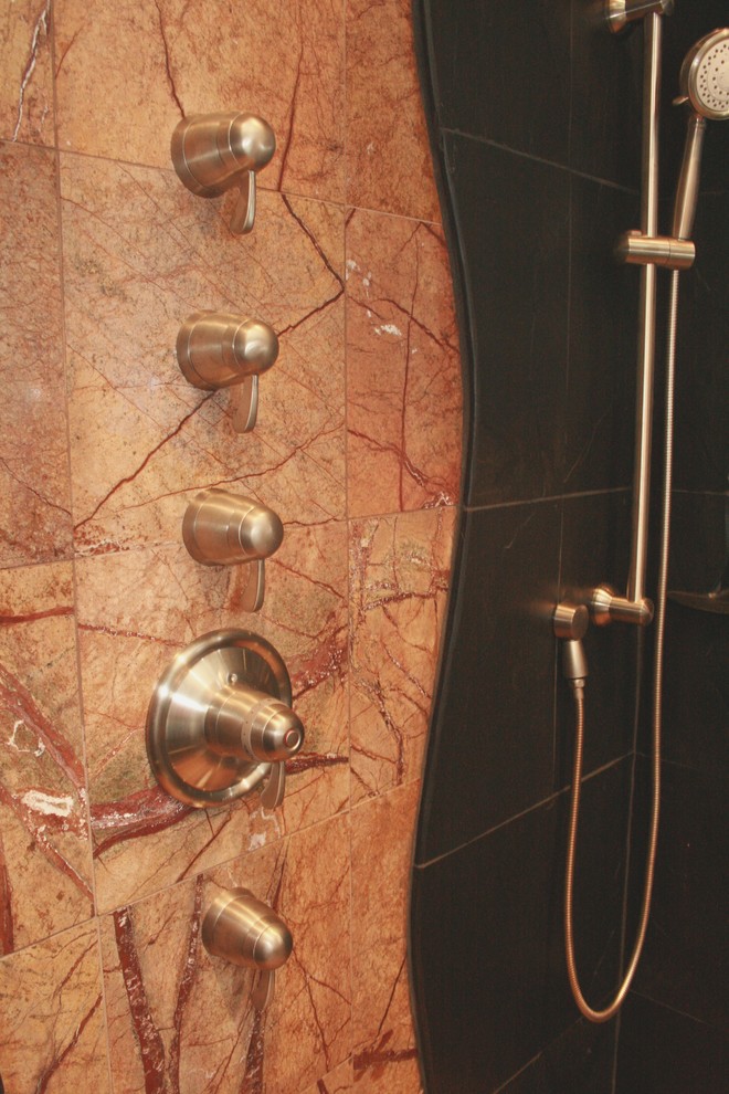 Example of a mid-sized trendy master brown tile slate floor freestanding bathtub design in Seattle with raised-panel cabinets, dark wood cabinets, beige walls and a drop-in sink