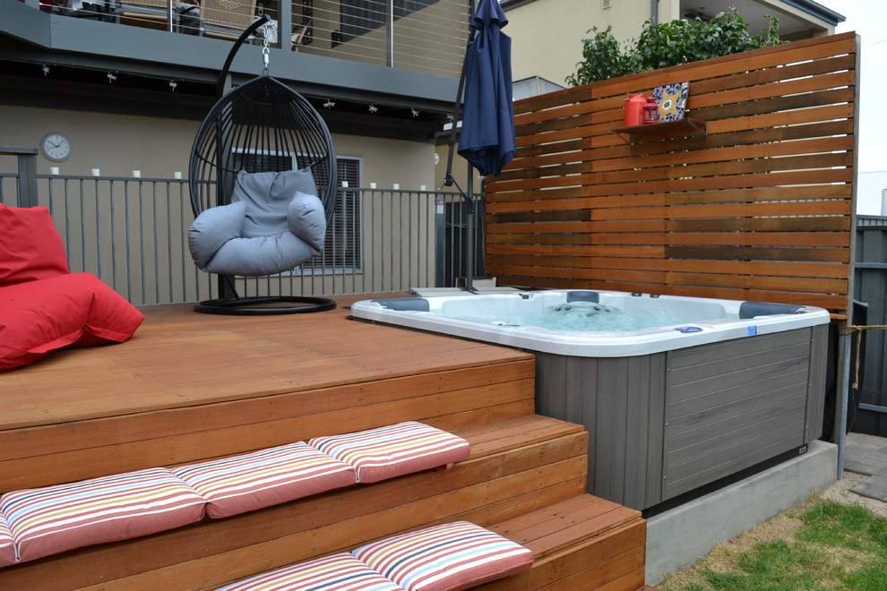 Photo of a small modern backyard pool in Adelaide with a hot tub and decking.